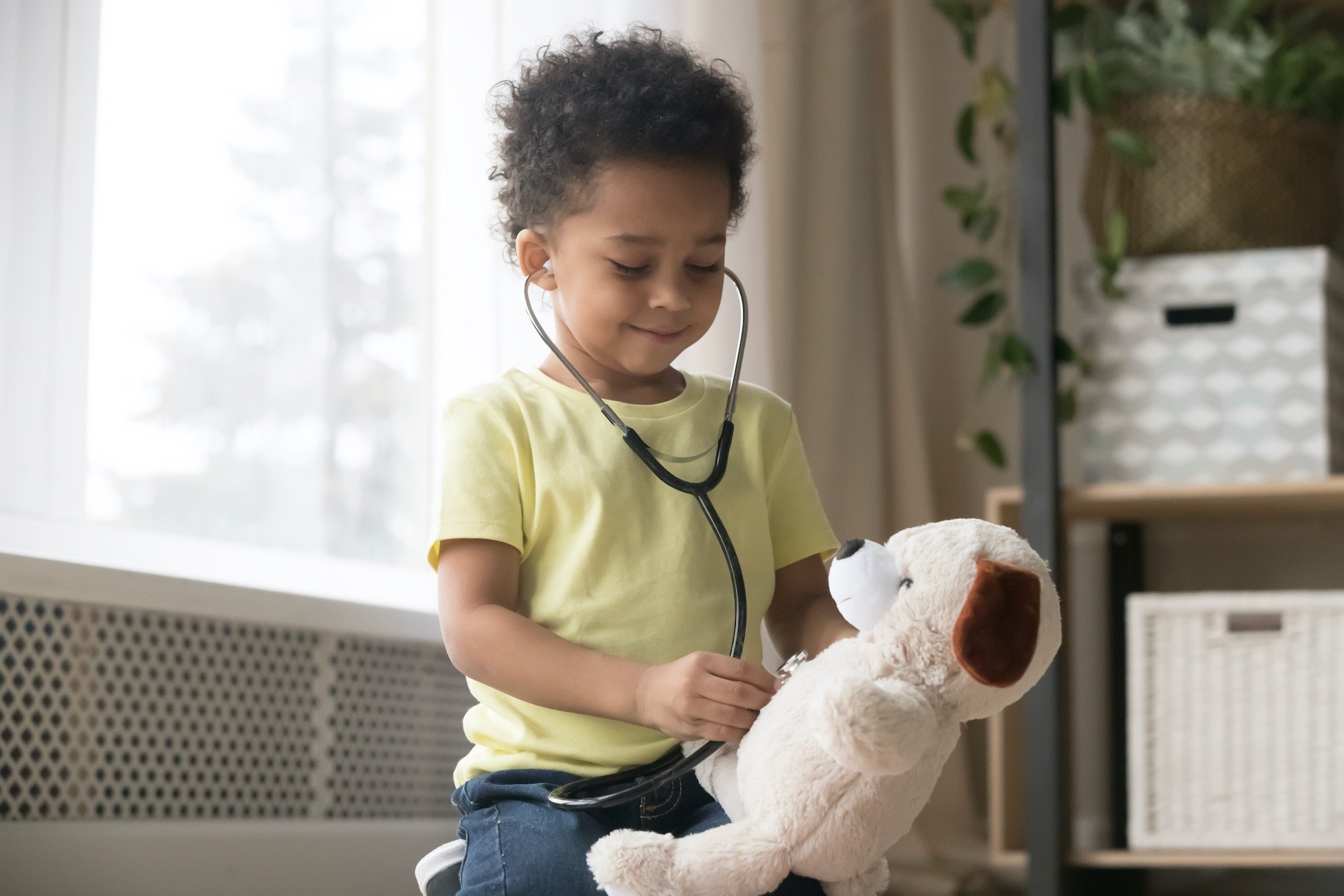 Young Pediatric Patient with Stethoscope Listening to Teddy Bear