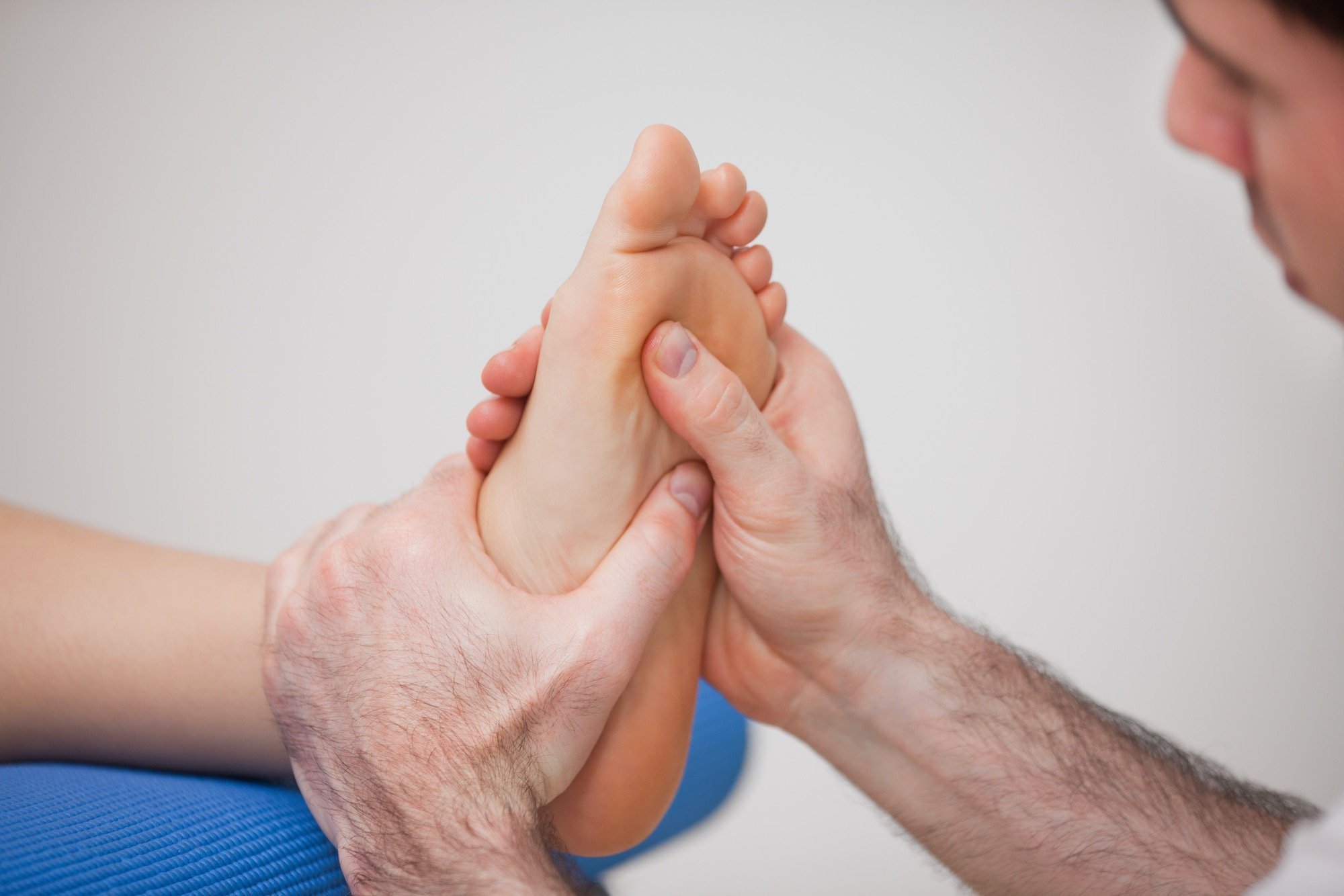 Man Sitting in Evaluation Before Laser Foot Therapy Injection