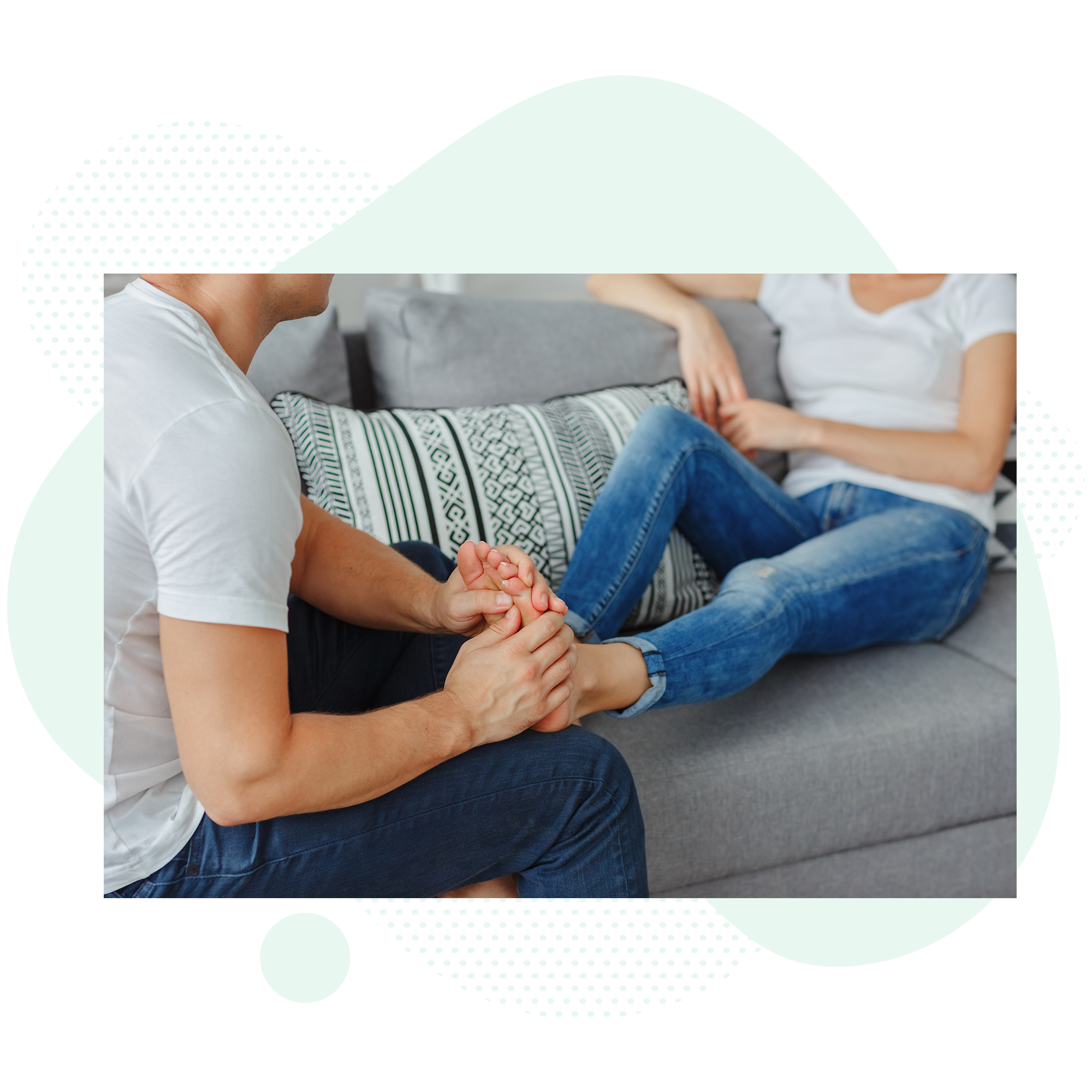 Man massaging woman's sore foot