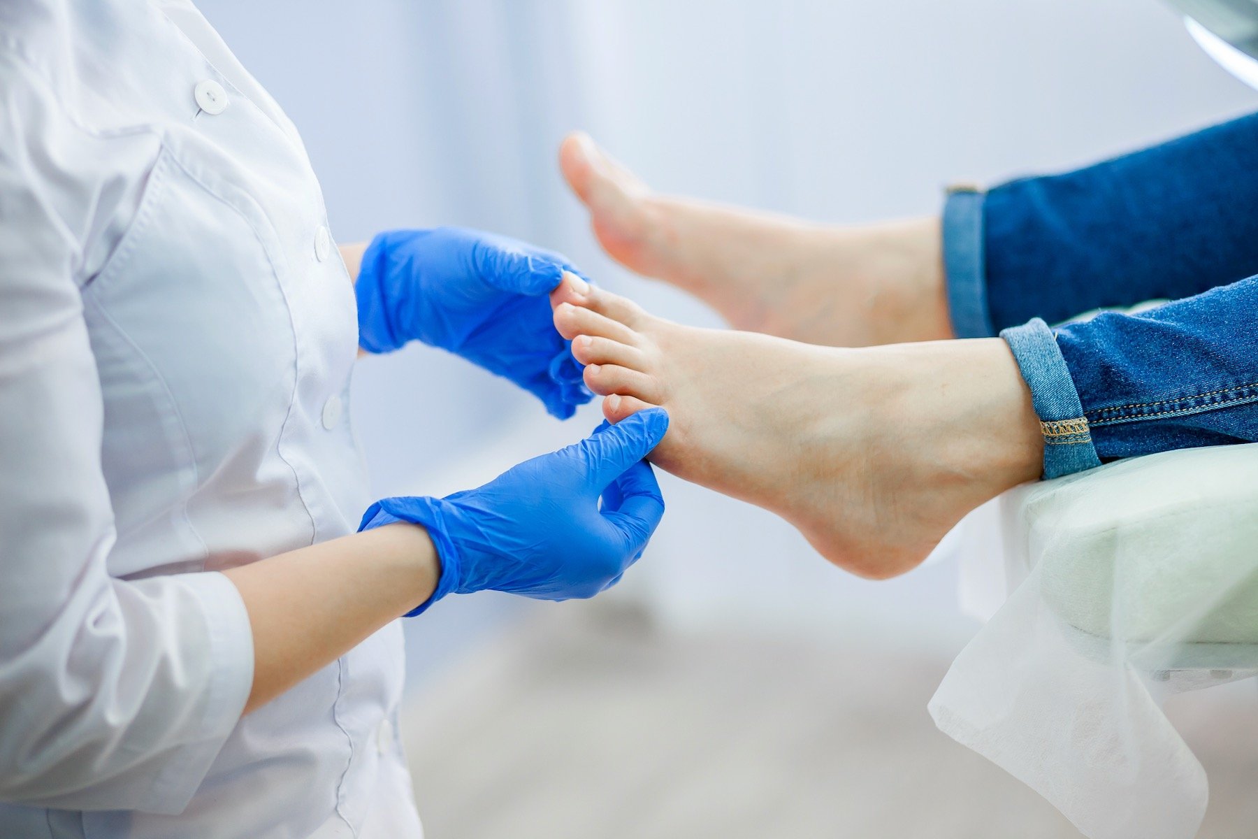 young-doctor-examinating-paitents-toenails-Arizona-Foot-Doctors